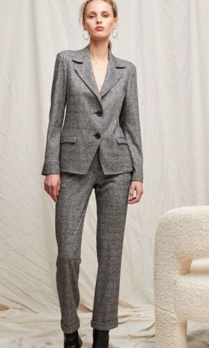 Descripción: Una mujer llevando una Chaqueta Príncipe de Gales en lana no forrada elástica gris y botas negras.